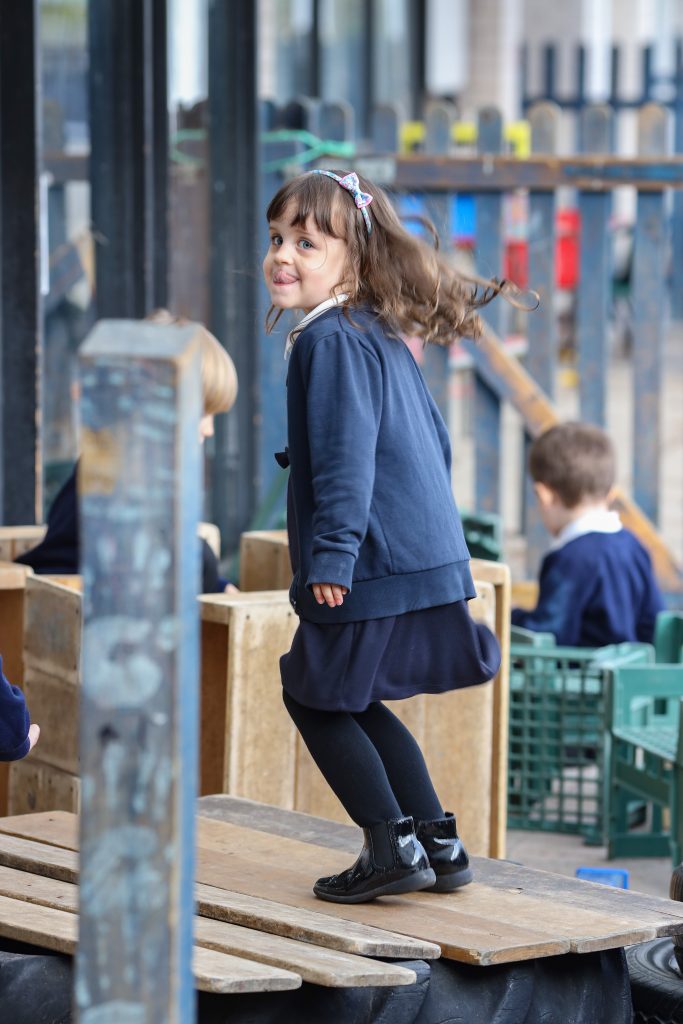 young pupil enjoying playtime in the school grounds